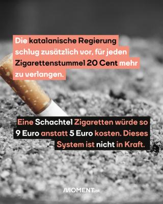 Zigarettenstummel liegt ausgedrückt auf dem Asphalt. 