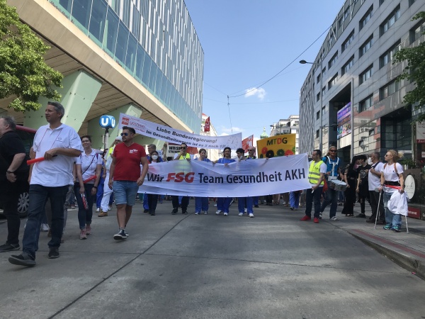Plegereform: Man sieht ein Banner der FSG und Menschen, die an einer Demo teilnehmen