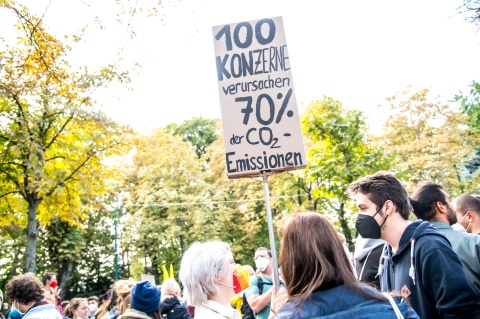 Plakat: "100 Konzerne verursachen 70% der CO2-Emissionen" beim Klimastreik 2021 in Wien